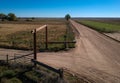 Open gate at junction of dirt roads