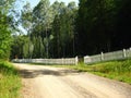 Open gate at long white fence Royalty Free Stock Photo