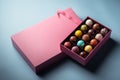 Open gift box with assortment of homemade hand painted chocolate bonbons. AI generation