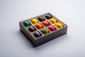 Open gift box with assortment of homemade hand painted chocolate bonbons. AI generation