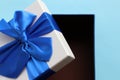 Open gift box with blue ribbon on blue background. Fathers day present for dad. Top view, copy space Royalty Free Stock Photo