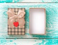 Open gift box on blue vintage wooden desk top view.