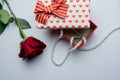 Open gift box with red hearts and rose on a white background Royalty Free Stock Photo