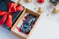 open gift box with a remotecontrol car inside, on a white backdrop Royalty Free Stock Photo