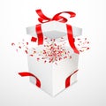 Open gift box with torn red satin ribbon. Bow and Confetti flying out of surprise. Isolated on white Royalty Free Stock Photo