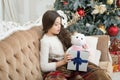 Open gift. Winter wonderland. Adorable girl play with toy in christmas eve. Present concept. Smiling child enjoy winter