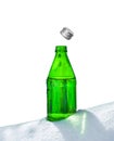 Open glass bottle of mineral water in snow Royalty Free Stock Photo