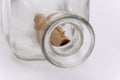 An open glass bottle with an old note inside on a light background, the cork lies next to it. Concept: sea mail, a message from an Royalty Free Stock Photo