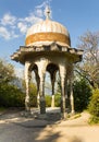 Open graceful stone gazebo pavilion with carved walls and a round roof