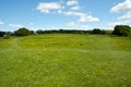 Open grasslands where The Cotswold Way long distance footpath passes Standish Wood viewpoint. Royalty Free Stock Photo