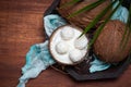 Open and grated coconut on a wooden table with coconut dessert balls top view Royalty Free Stock Photo