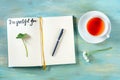 Open gratitude journal with a pen and a cup of tea, with the handwritten phrase I am grateful for Royalty Free Stock Photo