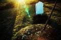 Open grave with shovel at sunset