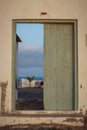 Green wooden door through a wall