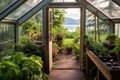 open greenhouse door with view of outdoor garden Royalty Free Stock Photo