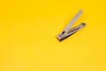 An Open Grey Nail Clipper in The Corner of Yellow Background Royalty Free Stock Photo