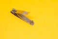 An Open Grey Nail Clipper in The Yellow Background with Oblique Shot Royalty Free Stock Photo