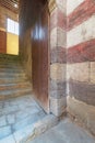 Open grunge wooden door revealing old stone staircase going up, Cairo, Egypt