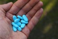 Open hand with a bunch of blue pills Royalty Free Stock Photo