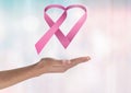 Open hand with pink ribbon for breast cancer awareness Royalty Free Stock Photo