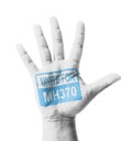 Open hand raised, Unite for MH370 sign painted Royalty Free Stock Photo