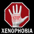 Open hand with the text stop xenophobia. Global social problem