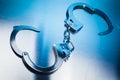 Open Handcuffs on a metallic background with dramatic lighting Royalty Free Stock Photo