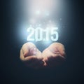 Open hands holding number 2015. Happy New Year. Royalty Free Stock Photo