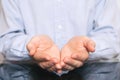 Open hands of man sign of begging. man in shirt holding something imaginary on palms of his hands Royalty Free Stock Photo