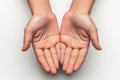 Open hands reaching out in a warm gesture of offering in a bright and minimalistic setting