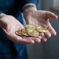 Open hands showing golden coins representing bitcoins. Concept investment in cryptocurrencies Royalty Free Stock Photo