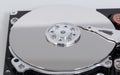 Open hard drive with magnetic disk and writing head Royalty Free Stock Photo