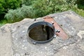 Open hatch for descending into the bunker of the German coastal anti-aircraft battery `Lemberg.` Baltiysk, Kaliningrad region