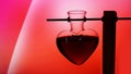 Open heart-shaped bottle of red love potion on a blurred background Royalty Free Stock Photo