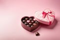 Open heart-shaped box with chocolate candies on a pink background. Generative AI