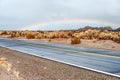 Open highway and rainbow Royalty Free Stock Photo