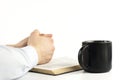 Open holy bible book on a white table. Scripture. Hands in prayer. A cup Royalty Free Stock Photo