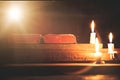 Open Holy Bible and candle on a old oak wooden table. Beautiful gold background. Royalty Free Stock Photo