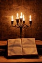 Open Holy Bible and candle on a old oak wooden table. Beautiful gold background. Royalty Free Stock Photo