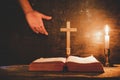 Open Holy Bible and candle on a old oak wooden table. Royalty Free Stock Photo