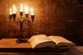 Open Holy Bible and candle on a old oak wooden table. Royalty Free Stock Photo