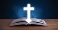 Open holy bible with glowing cross in the middle Royalty Free Stock Photo