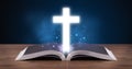 Open holy bible with glowing cross in the middle Royalty Free Stock Photo