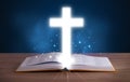 Open holy bible with glowing cross Royalty Free Stock Photo