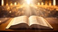 Open Holy Bible with glowing lights in a church