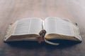 open holy bible and rosary with cross on wooden Royalty Free Stock Photo