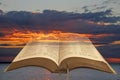 Open holy bible and storm clouds sunset Royalty Free Stock Photo