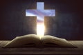 Open holy bible with wooden cross in the middle Royalty Free Stock Photo