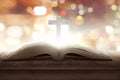 Open holy bible with wooden cross in the middle Royalty Free Stock Photo