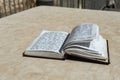 The open  holy book of Jews with the text of prayers in Hebrew - Tehelim, lies on a table near the Western Wall in the old city. Royalty Free Stock Photo